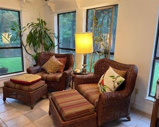 Medium brown wicker oversized chairs with foot stools and seat cushions, vintage brass base lamp, cushions