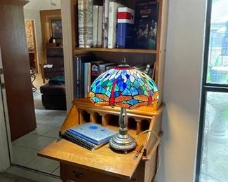 Vintage  narrow Maple Secretary, perfect for smaller spaces. Wonderful stained glass table lamp, vintage books with Texas titles.