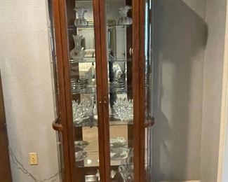 Vintage display cabinet with glass shelves and mirror back. 