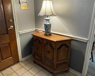 Vintage solid rock maple entrance cabinet, blue and white ceramic table lamp.