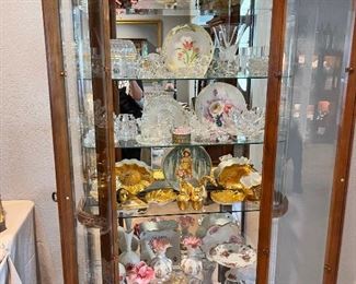 Vintage lighted collectors cabinet, Distinguished china 22k gold overlay, framed feather fan, Fenton plate, hand painted plates, glass figures, ruffled edge vase, clear glass vases