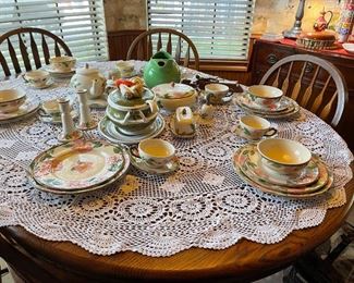 Kitchen oak table with leaf installed and six chairs. English Franciscan, vintage ceramic vegetable bowl with under plate, vintage Hall green pitcher