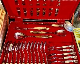 We have this “ivory color” BIRD handled set of flatware and we have the exact set with brown wood handles…see following pics. Super cool! The brown set is actually the larger set. 