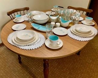 Kitchenware settings for 8 or more. Kitchen table and 2 captain-style chairs.
