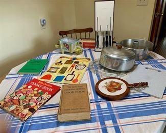 Vintage cookbooks, kitchenware (cake plate and cover, angel food cake mold, knife sets, cutting board, planter
