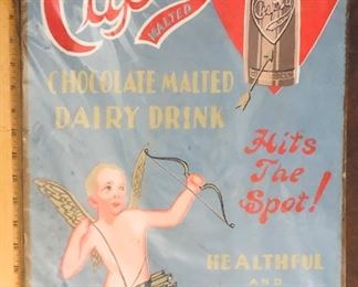 Behold, an original paperboard Cupid Chocloate Malted Dairy Drink Sign going up for your consideration on Tuesday evening with a reasonable reserve. 

You may have seen a similar version as this sign was reworked and reproduced in tin as a decor item in modern times on account of its amazing graphics but nothing compares to how breathtaking the original is. 

This sign is often incorrectly attributed to the 1930s. It is more likely to have been created in 1909-1910 on account of the construction of the sign, the typeface and print style and the fact the Westchester Bottling Wks of New Rochelle, NY was in bankruptcy by 1911 on account of overextending themselves with expansion plans the years previous. 

If you’re a Victorian era paper collector, a beverage sign collector, an antique Valentine enthusiast or into quackery, this is an excellent piece to add to your collection. Measures 22”x14.25” - some stippling bottom left and worn to rounded corners from age. It’s currently plastic wra