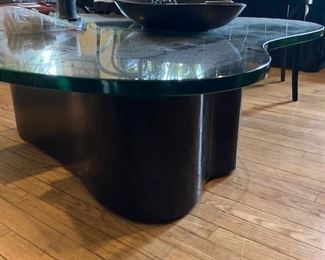 Coffee table has green edge half inch glass