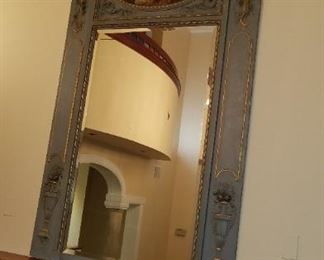 large, ornate mirror, pictured over mantle