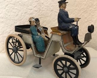 Antique tin automobile.. car with figures 