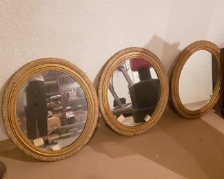 Oval gilded mirrors