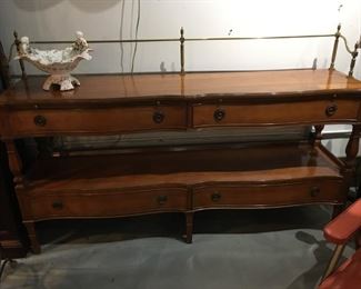 Serpentine front buffet/console table with pull out shelves and brass rails