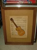 "Camptown Races" sheet music, framed with a 3-D mini Guitar over it. I don't understand it, either, but it looks cool....doo daah, doo daah.