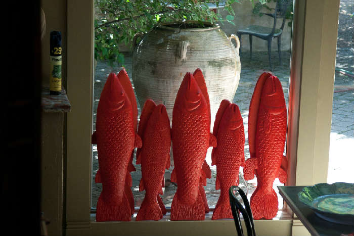 Five of many plaster fish that were painted this gorgeous red that formerly were hung in the restaurant.
