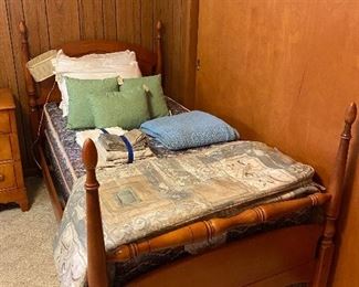 Maple twin bed frame and twin mattresses has a matching bedframe