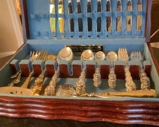 Oneida Community silverplate - 8 pc place setting with serving pieces.  Also pictured are two place setting of gold-plated flatware and silver and gold anniversary cake servers.