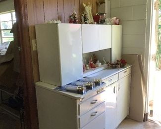 Miscellaneous seasonal items.  Three separate cabinet pieces.  Top cabinet shows significant rust on open shelf