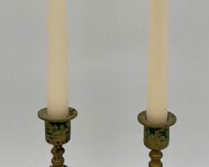 Vintage painted brass candlesticks with candles