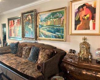 The sofa is accented with long fringe and decorative pillows.