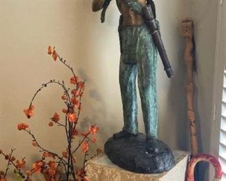 Bronze Native American statue; walking sticks