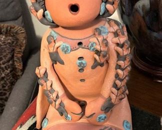 A Storyteller Doll is a clay figurine made by the Pueblo people of New Mexico. 
