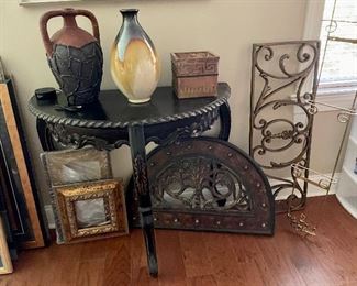 Nice black half table, pottery and metal decorative pieces.