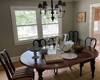 Large dining table with leaf, 6 matching chairs, corner cabinet, sisal rug.