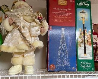 old world Santa, lighted outdoor tree, Christmas lamp post