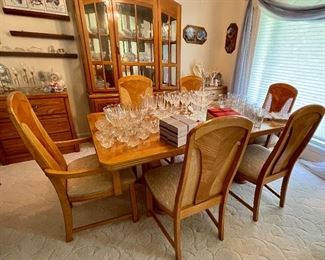 oak dining table with 6 chairs and 2 leaves, lots of crystal