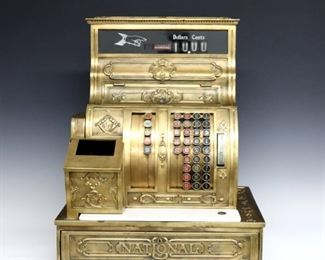 A turn of the century National Model 1054G cash register.  Brass construction with push button register up to $59.90.  Some wear and minor damage, lacks glass in print-out cover.  19 x 15 1/2 x 23" high overall.  ESTIMATE $300-400