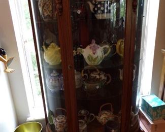 curved glass china cabinet, large teapot collection