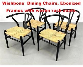 Lot 449 4pc Hans Wegner style Wishbone Dining Chairs. Ebonized Frames with woven rush seats. 
