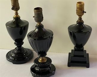 Three Black Art Deco Houze Lamps in similar but different designs.  Measuring about 12". These lamps do not have their electrical components. 