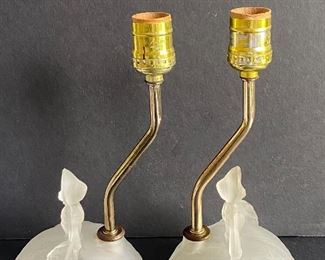 Pair of Figurine Satin Glass Boudoir Lamps possibly by L.E.Smith. Each lady figurine has a small chip on the bottom of her skirt and these lamps do not have the electrical component. These lamps each measure 10" and are in vintage condition with some wear including some scratch marks and wear to the brass posts. 