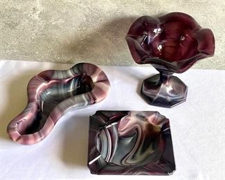 Three Pieces of Beautiful Houze Slag/Marble Like Glass including a hambone Houze ashtray. The swirls/patterns are beautiful in these pieces!  The pedestal dish measures 4.5" h. The square ashtray exhibits some flea bites/small chips.  