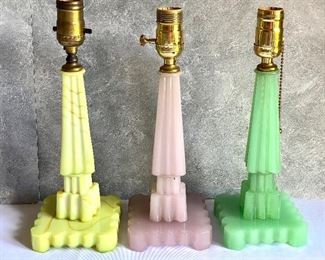 Set of Three Vintage Art Deco Houze Glass Table Lamps includes a yellow swirl design lamp, nile green, and a coralex (soft pink) lamp.  Each measures 12" and does NOT have the electric component. The nile green lamp has a small chip. 