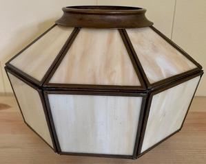This vintage pendant shade is made of plastic and metal. It measures 7 inches and 13 inches in diameter. 