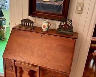 Smaller slant front desk, mirror, iron door stops, and majolica pitcher.