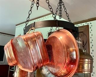 Wonderful collection of copper pots and pot hanger.