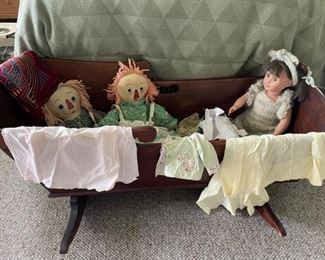Antique cradle, clothing, and dolls