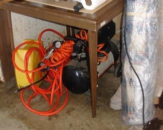 Compressor and bolts of fabric next to it - much more fabric in house and in bins