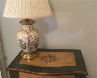 DETAIL OF TOP OF WOODEN, PAINTED JEWELRY CABINET WITH FLORAL LAMP