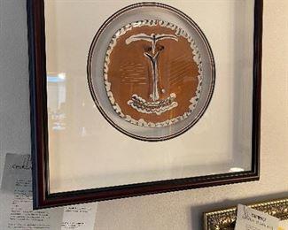 PABLO PICASSO: "Visage au Nez Pince" (Face with Pinched/Pursed Nose) - 1959.  10.25" x 10". White earthenware clay plate, painted and partially glazed.  Imprinted with the "Empreinte Originale de Picasso"  and "Madoura Plein Feu" stamps on the verso.  From the numbered edition of 100 examples.  In July of 1946, Picasso and his friend Louis Fort visited the potters exhibition in Vallauris, France.  Here Picasso saw the Madoura ceramics display and was invited to see the workshop.  Inspired, he created a few pieces that day and returned a year later in anticipation of working again.  *More information available upon request and all information is based on the Certificate of Authenticity issued by Park West Gallery at the time of sale:  12/24/2007.  