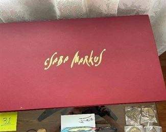 CSABA MARKUS - "Rosso Portfolio III" - 2014 - 8" x 11" contained in a custom designed portfolio case measuring 16.5" x 29.25".  A collection of five mixed media graphics on acid-free paper, each hand-signed and numbered, paired with a hand-signed and remarqued silk covered deluxe edition of the book; "Csaba Markus - Artist and the Muses," contained in a portfolio.  From the Arabic numbered edition of 99 examples (10 Arabic numbered artist proofs and 10 Arabic numbered printer proofs also exist).  Information based on Certificate of Authenticity provided at the time of purchase from Park West Gallery; 12/12/2015.  