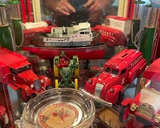 An original Texaco Service Station Ashtray is front a center in this collection of ERTL Replicas of various Texaco Trucks, Boats and Gas Pumps.  