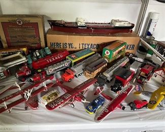 Most of the items seen on this table and corresponding shelves have their original boxes, too!  