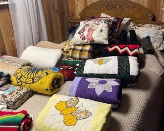 Quilts, both machine and hand quilted, plus various blankets and throws adorn the downstairs bed.  (Bed is NOT for sale.)  