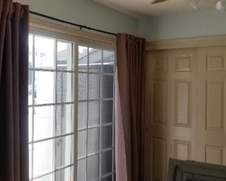 Blackout curtains in neutral tones; nice sliding closet doors