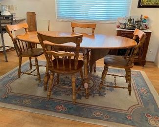 Solid wood drop leaf table w/ 4 chairs. also comes with leaf extensions and a card mat to protect the top.