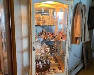 Lighted curio cabinet and figurines