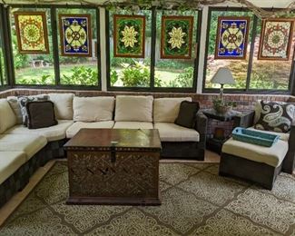 Wonderful screen porch, with entire 15-piece suite of "Summer Classics"  (Pelham, AL) of woven, N-Dura resin wicker, from ($25K when new) vintage Thai hand-painted mirrored wooden trunk, from Jeff Littrell, weather resistant rug and collection of Tiffany-style stained glass panels. 